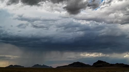 Timelapse of rain storm moving over the mountains in the West Desert