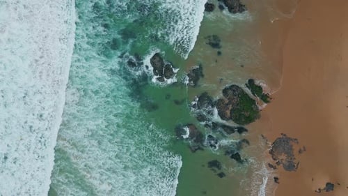 Rocky Stones Break Waves Display of Nature Power Aerial View Sea Meeting Beach