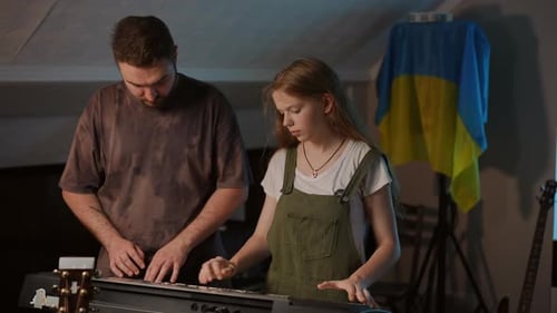 Girl and Man Play Music Together