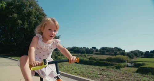 Child Riding Bike Outdoors on Sunny Day