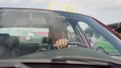 Male Taxi Driver Driving Around the City Slow Motion