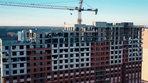 Aerial view of the construction site at winter. Flight near the building under construction