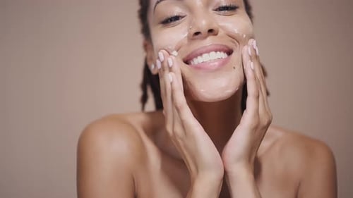 Woman Applying Refreshing Facial Mask at Home