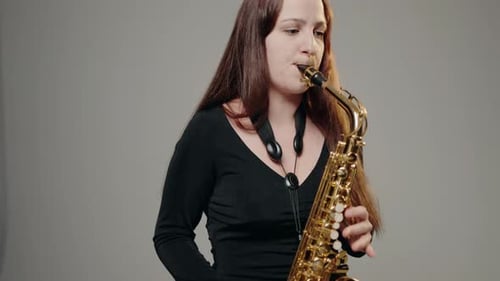 Woman Playing Saxophone in Studio