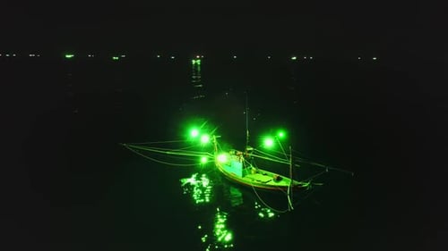 Fishing Boat Using Green Lights Attracting Squid at Night Near Koh Phangan Island Thailand