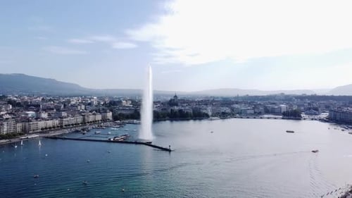 Geneva Cityscape with Lake Jet d'Eau Water Fountain - Aerial Pullback