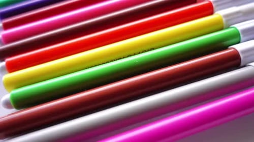 Colorful Markers Lying in a Row Close Up