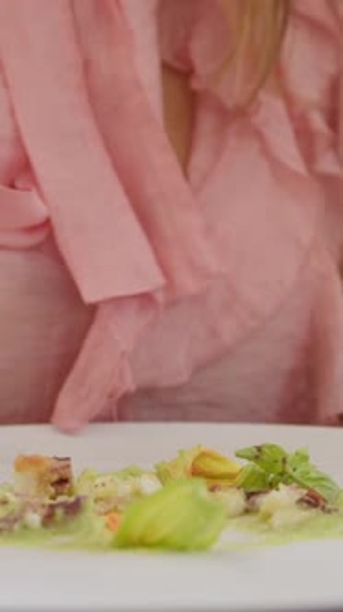 Elegant Dish of Octopus and Squash Blossom Being Tasted