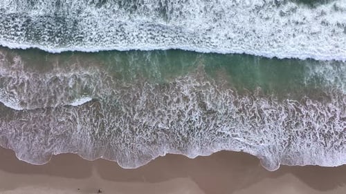 White Foam Spreading on Beach From Drone Drone View of Crashing Foam Waves Sea Foam Patterns From