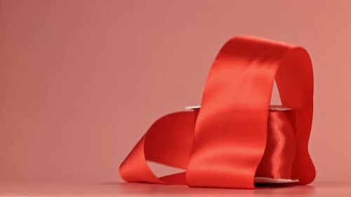 A Red Ribbon Falls on the Table Filmed on a Highspeed Camera at 1000 Fps