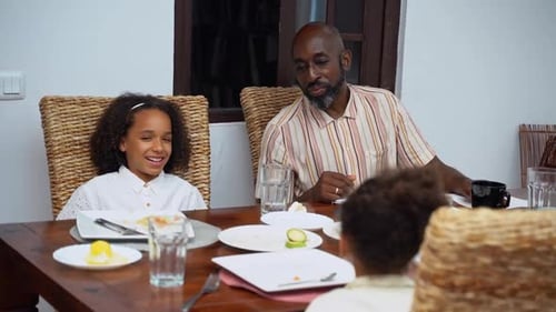 Father and Children Enjoy Meal Together at Home