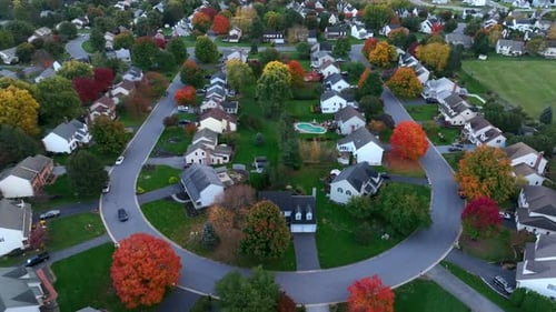 Residential street in autumn. Colorful fall foliage with American suburbia. Houses and homes along q