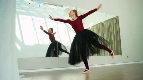 Graceful Ballerina Performing Classical Ballet Dance in Studio