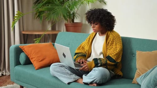 African American Girl Using Laptop at Home Office Looking at Screen Typing Chatting Reading Writing