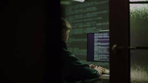 Young Man Coding Late at Night at Computer