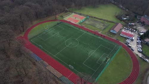 Aerial View of Stadium in Small Town Players Play Football on Soccer Field