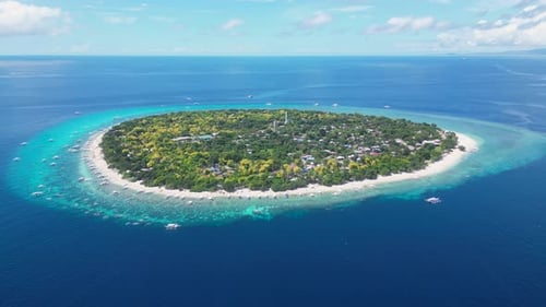 Aerial View of a Large Round Island in the Middle of the Blue Deep Sea A Green Island with a Huge