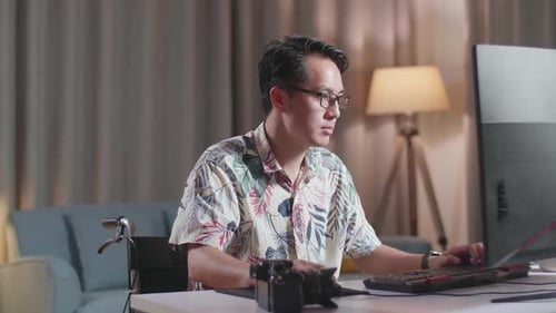 Adult Working at Computer in Wheelchair at Home