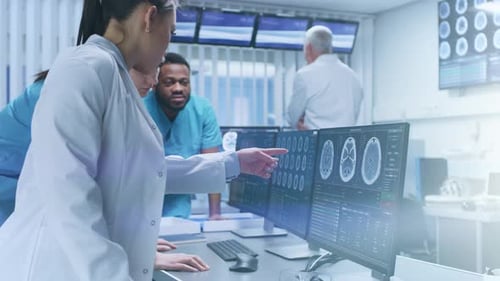 Diverse Team of Medical Scientists Solve Problems and Point at Computer Screens Showing CT, MRI Sca