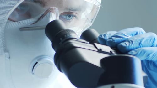 Scientist Using Microscope in Laboratory, Close Up