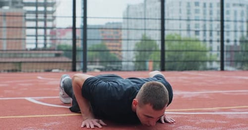 Man in Sportswear Doing Pushup Exercise on Basketball Court Healthy Lifestyle and Sport Concept