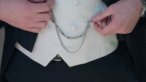 Formally Dressed Man Adjusting Pocket Watch Chain