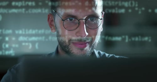 Cinematic shot of programer smiling satisfied while busy working with latest innovative sophistica
