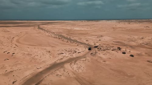 Aerial 4k Drone Footage of a car driving through a desert