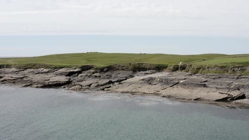 Aerial ascends over Tramore dunes revealing Atlantic Ocean off Ireland