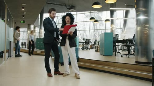 Business Professionals Reviewing Documents in Modern Office