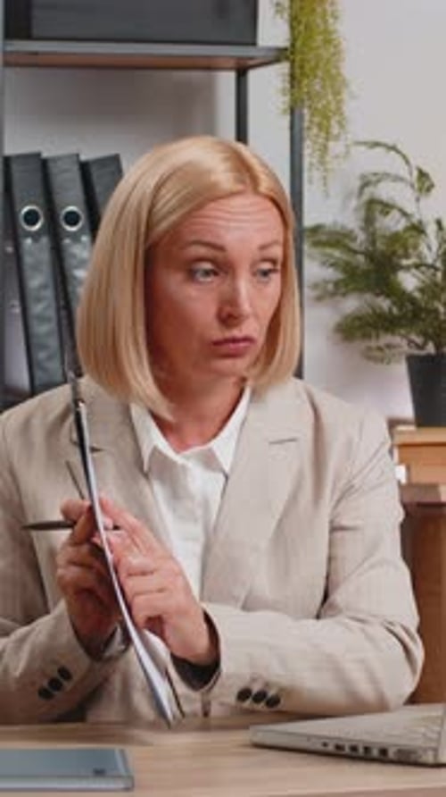 Mature Businesswoman Using Laptop Talking on Online Communication Video Call at Home Office Desk