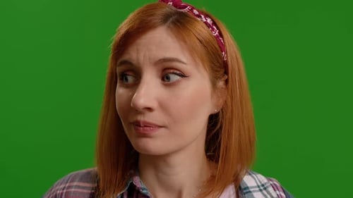 Woman amazed while looking around being bit scared in studio isolated on a background mockup.