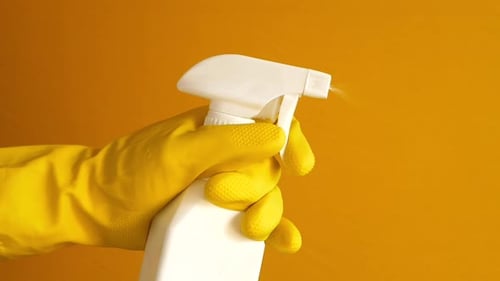 Holding a Plastic Bottle Spraying Disinfect