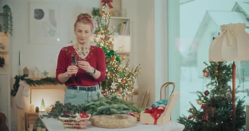 Woman Preparing Christmas Wreath Garland For Christmas Holidays