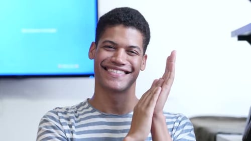 Smiling Young Adult Clapping Hands