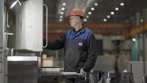 A Highly Skilled Worker Expertly Operating Advanced Machinery in a Modern Workshop Setting Stock