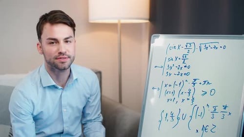 Young Man Explaining Math on Whiteboard