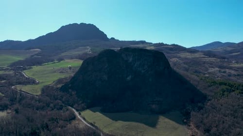 Aerial footage of Pietra Perduca and Barcellara, volcanic rocks, church set at top stone immersed in
