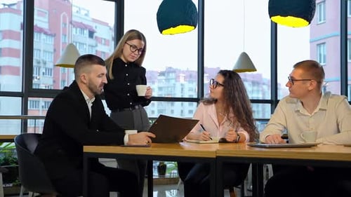 Workmates having discussion sitting at the big table