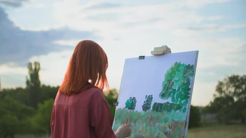 Creative Hobby Young Woman Draws with Paints and Brushes Painting Picture on Canvas While Standing