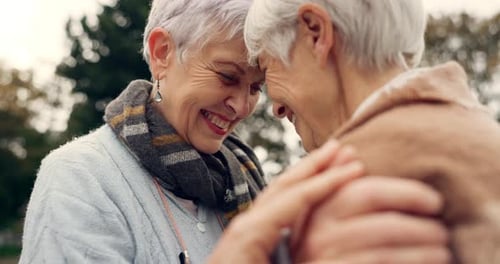 Loving Senior Women Embrace Outside