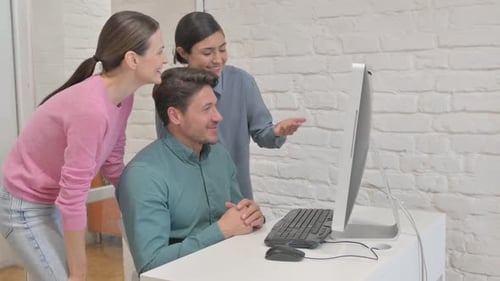 Coworkers Collaborate Using Computer for Video Conference