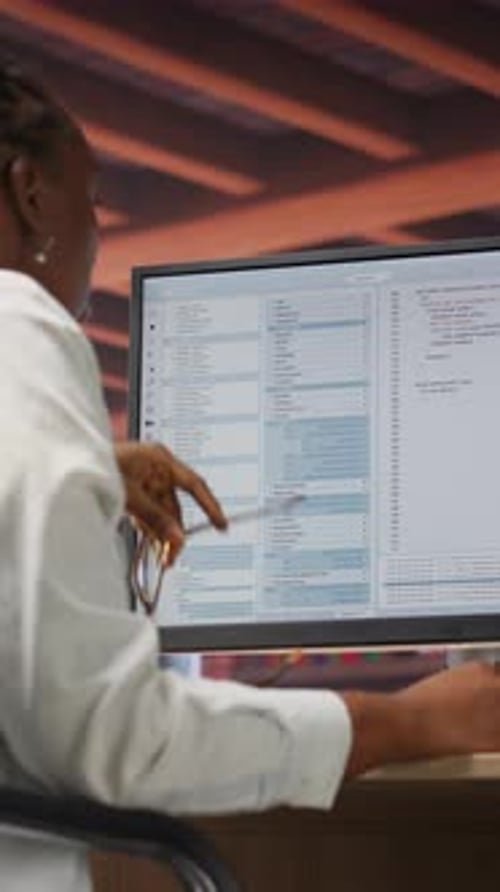 Woman Working at Computer in Office Setting