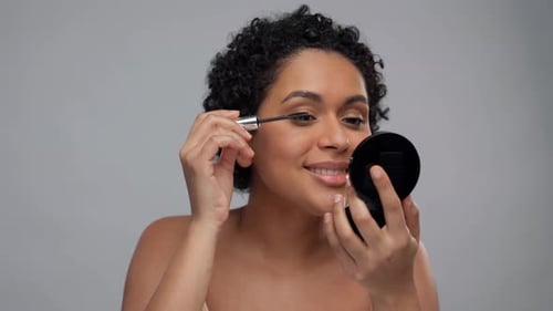 Beauty, Make Up and Cosmetics Concept - Smiling Beautiful Young African American
