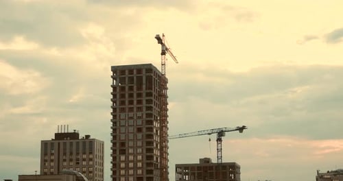 Construction Area in City Cranes Not Working with Sky and Clouds on Background