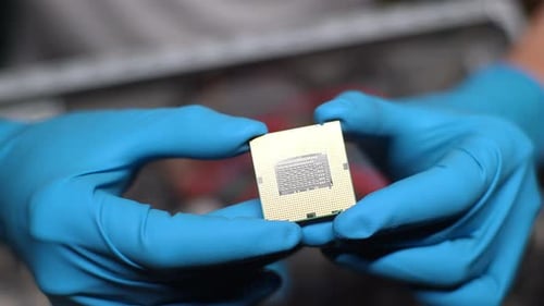 Closeup Gloved Hands of Unrecognizable Computer Scientist Holding New Semiconductor Microchip