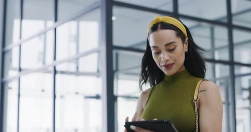 4k video footage of a young businesswoman using a digital tablet at work