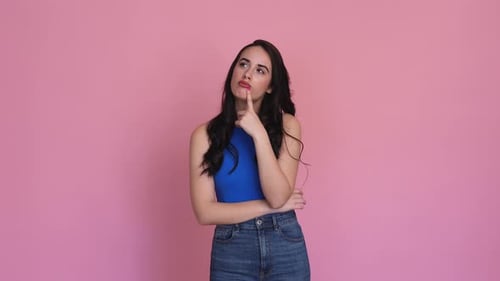 Woman Showing Doubt in a Studio Shot