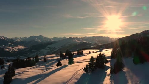 Golden Sun Light at Sunset in Mountains. Beautiful Sunny evening. Aerial view of Winter Mountains. B