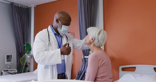Doctor Examines Senior Patient in Hospital Room